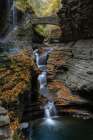USA, New York. Series of waterfalls and bridge in Watkins Glen State Park. Art Print